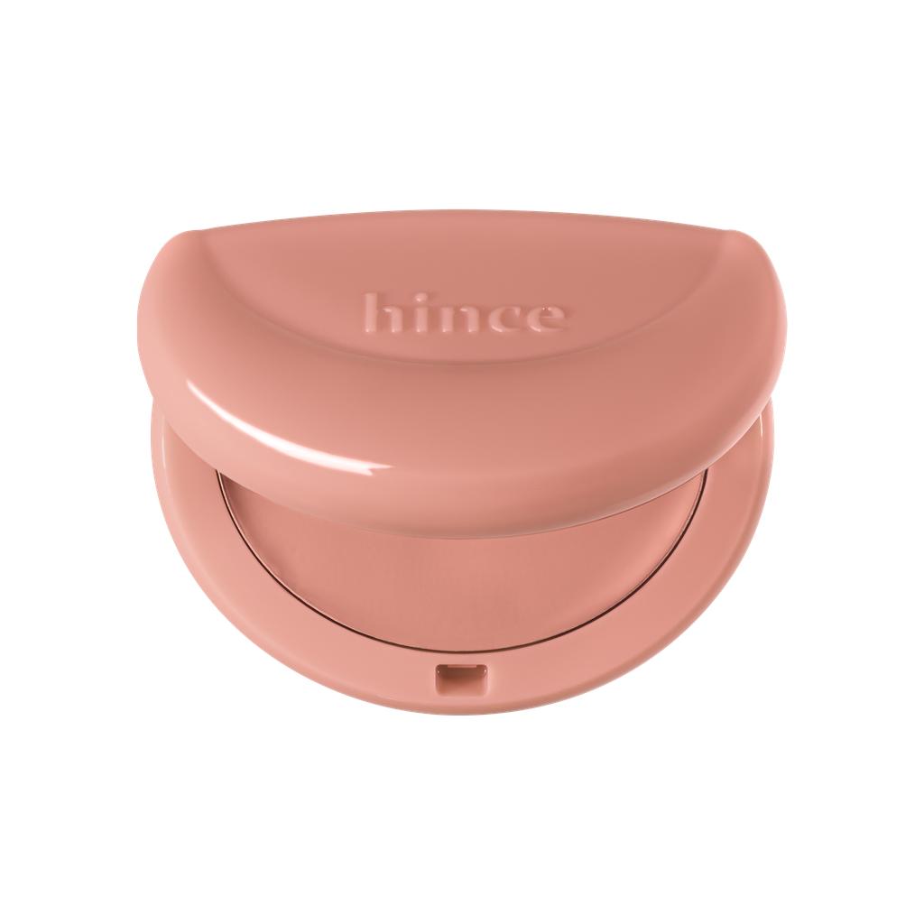 Hince Half-Moon Cheek Cream To Powder Blush in a compact with a soft pink shade and subtle moon-shaped design.