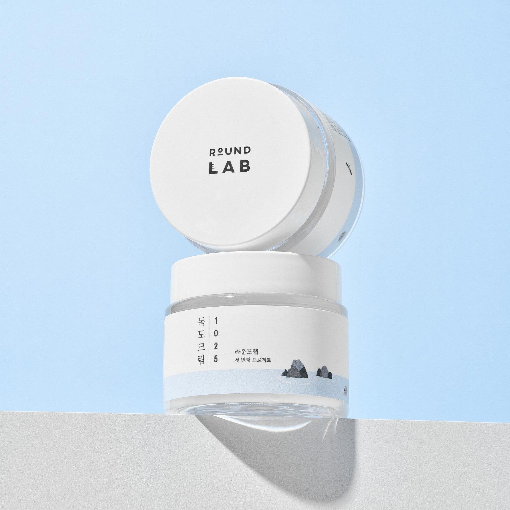 Round Lab Dokdo Cream face moisturizer jar, 80ml, with a white and blue packaging design, showcasing the skincare product.