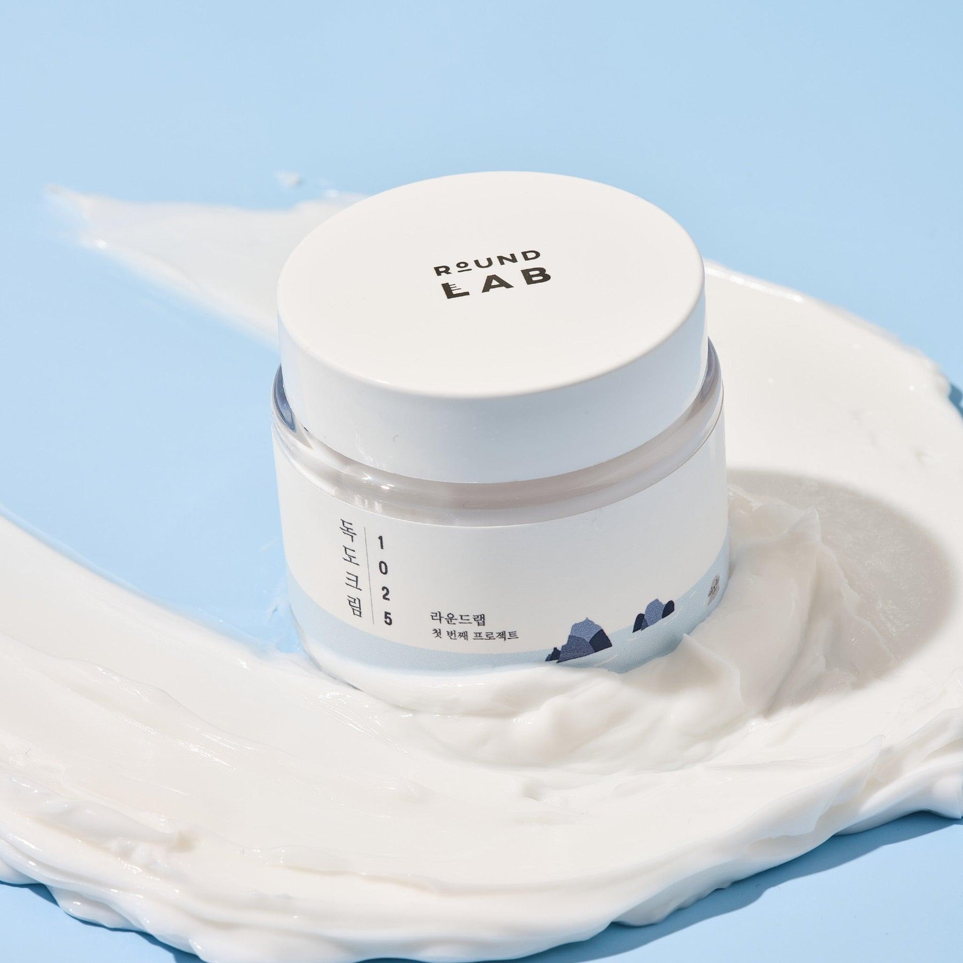 Round Lab Dokdo Cream face moisturizer in an 80ml jar, featuring a light, creamy texture and natural ingredients for hydration.