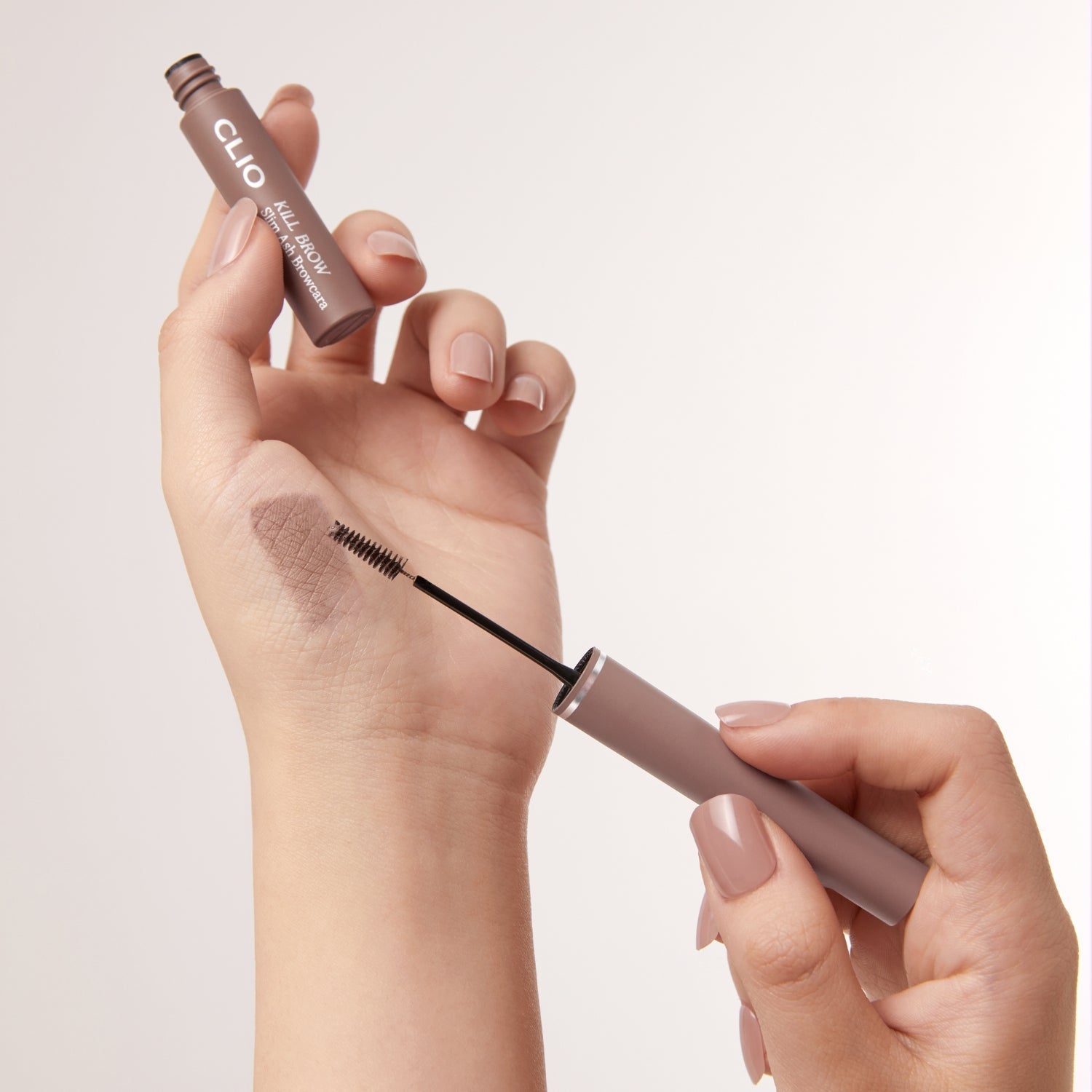 Clio Kill Brow Slim Ash Browcara showing slim eyebrow brush and ash-colored brow gel for natural, defined eyebrows