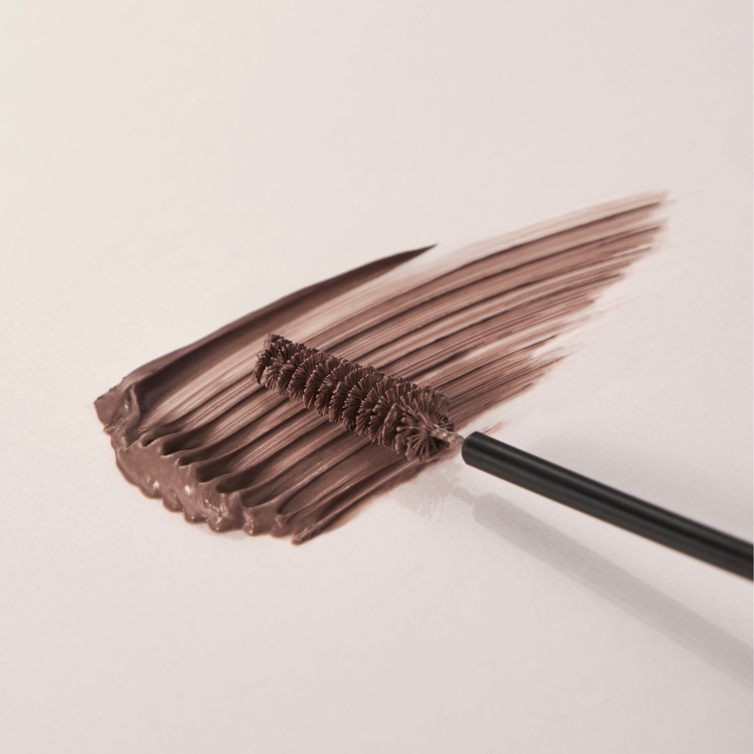 Clio Kill Brow Slim Ash Browcara displaying a sleek eyebrow brush and product tube for defining and shaping brows