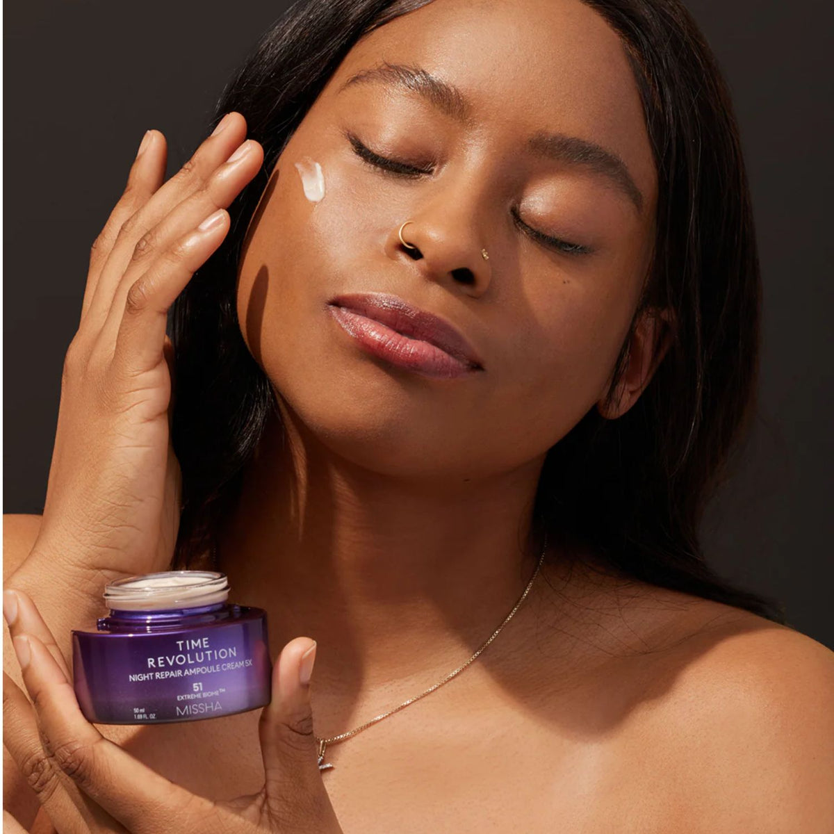 Missha Time Revolution Night Repair Cream and Balm duo set, featuring skincare products in white and gold jars on a neutral background.