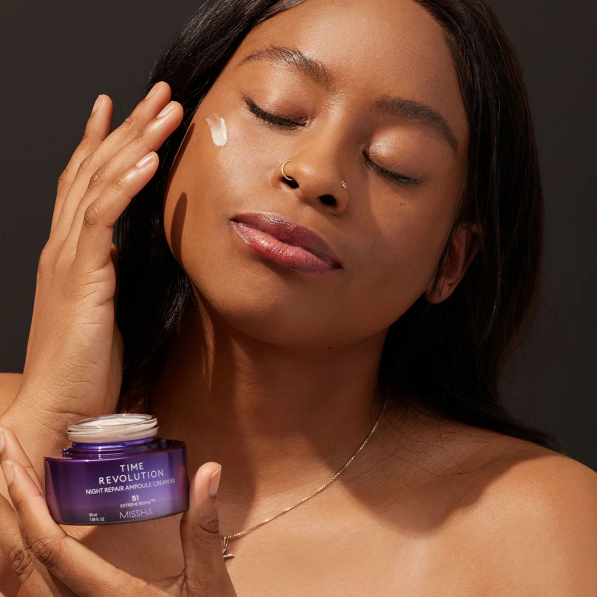 Missha Time Revolution Night Repair Cream and Balm duo set featuring skincare jars with labels, designed for nighttime skin renewal.