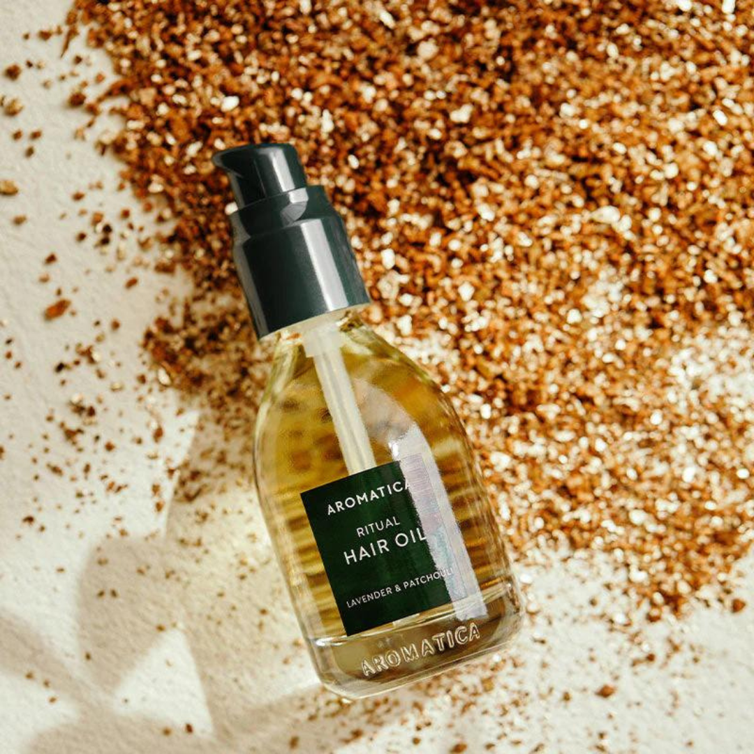 Aromatica Ritual Hair Oil with lavender and patchouli in a 50ml bottle, showcasing the hair styling product and its natural ingredients.