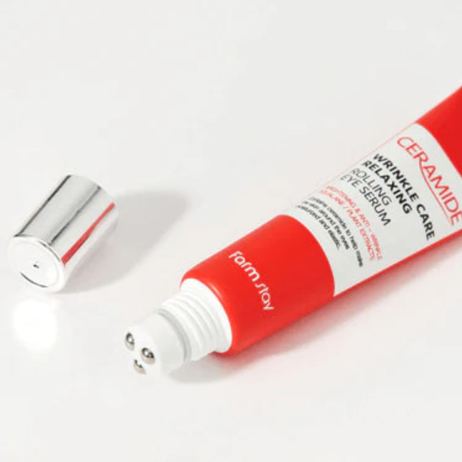 Farmstay Ceramide Wrinkle Care Relaxing Rolling Eye Serum bottle with applicator tip, 25ml, designed for reducing eye wrinkles and puffiness.