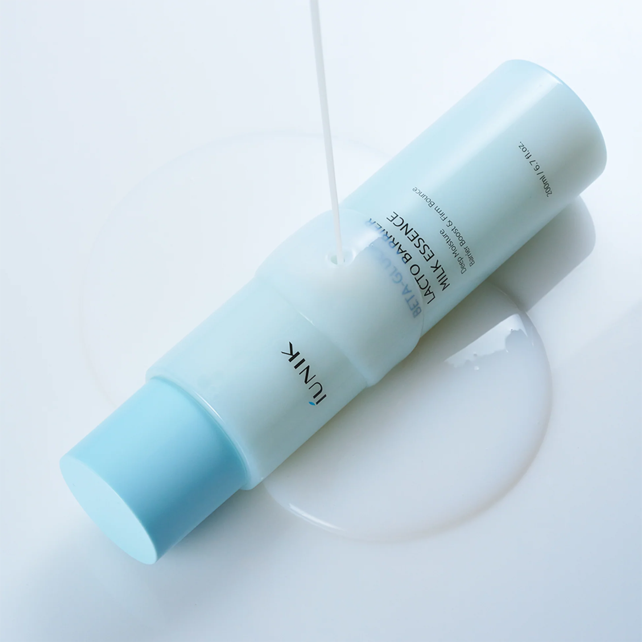 iUNIK Beta Glucan Lacto Barrier Milk Essence bottle, 200ml, with smooth, milky texture and protective skincare benefits.