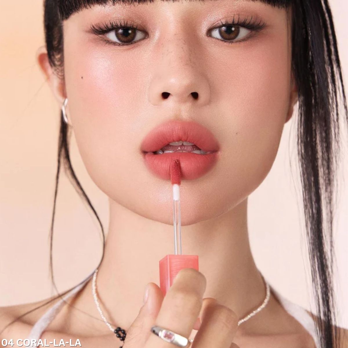Peripera Over Blur Lip Tint in a soft, natural shade applied on lips with a smooth, blurred finish showing the product packaging