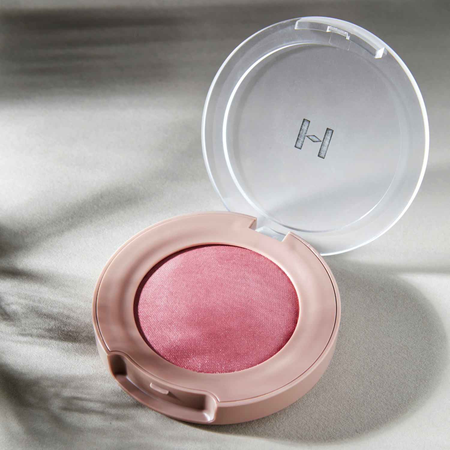 Hince True Dimension Glow Cheek blush with soft pink shade and smooth powder texture, displayed in a compact container.