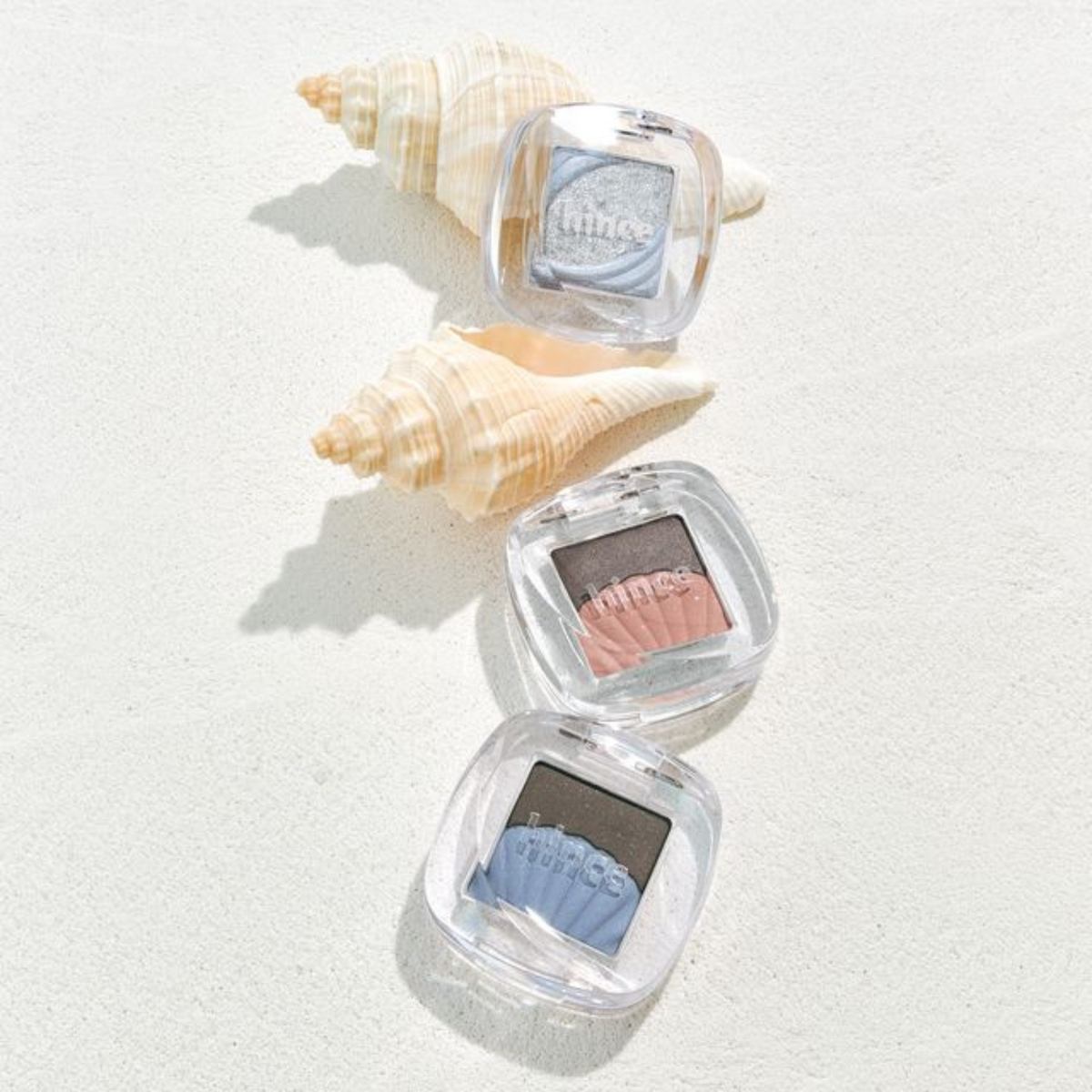 Hince Chill Voyage Edition single eyeshadow in a soft, shimmery beige with subtle sparkle, displayed in a sleek compact.