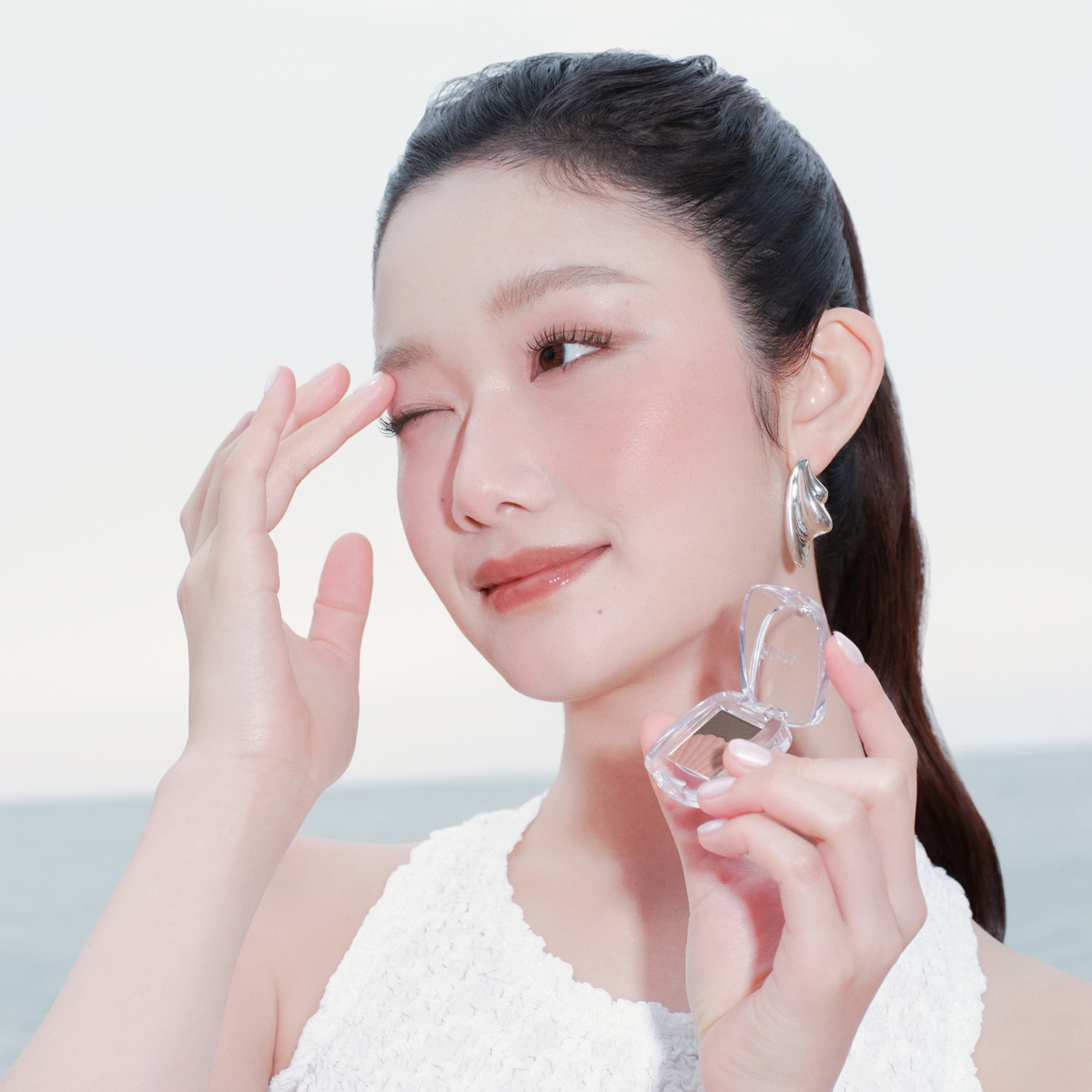 Hince Chill Voyage Edition single eyeshadow in a soft, shimmery neutral shade, displayed in a close-up view.