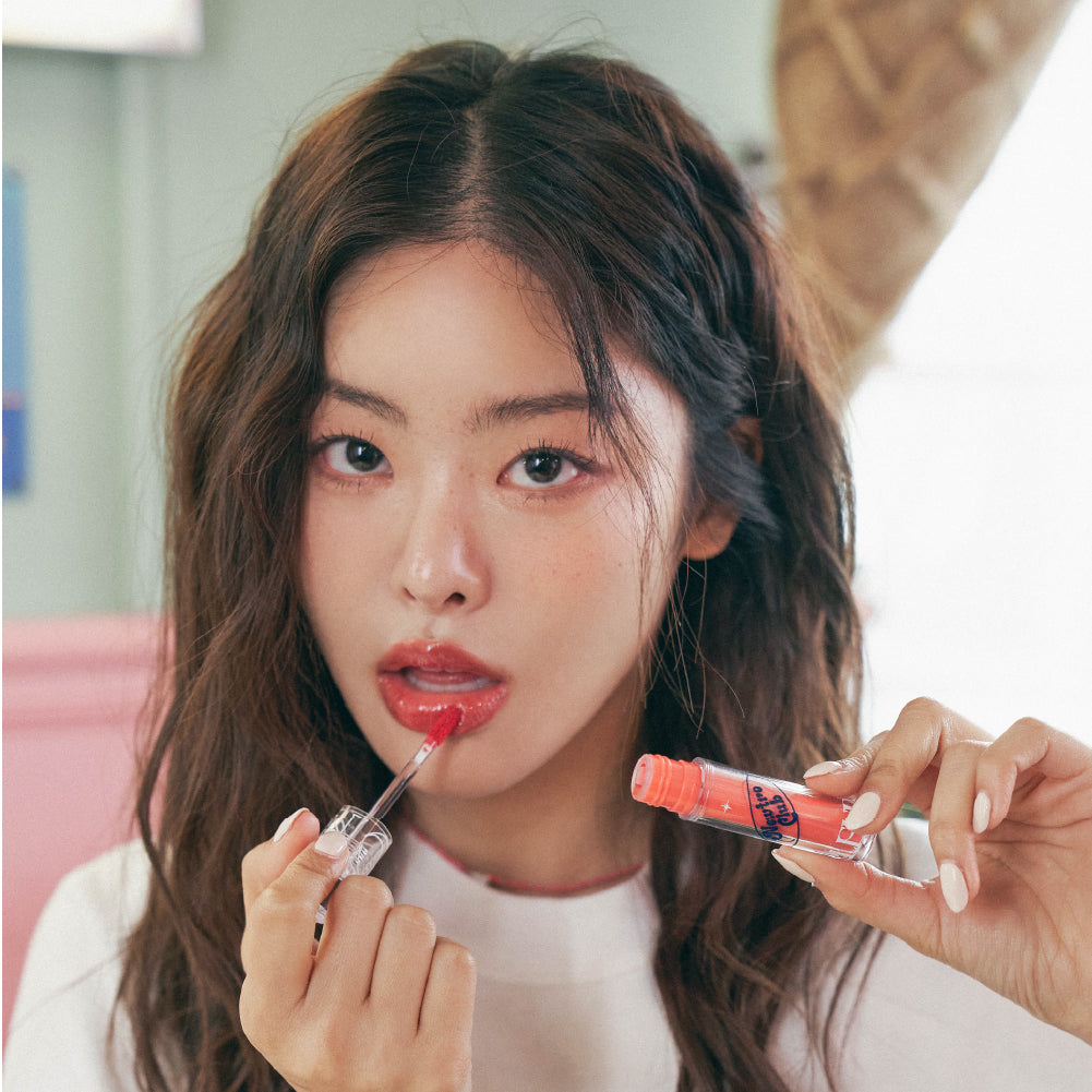 Too Cool For School Newtro Club Pleur Tint lip tint in a sleek tube, ready for application with vibrant color and glossy finish.