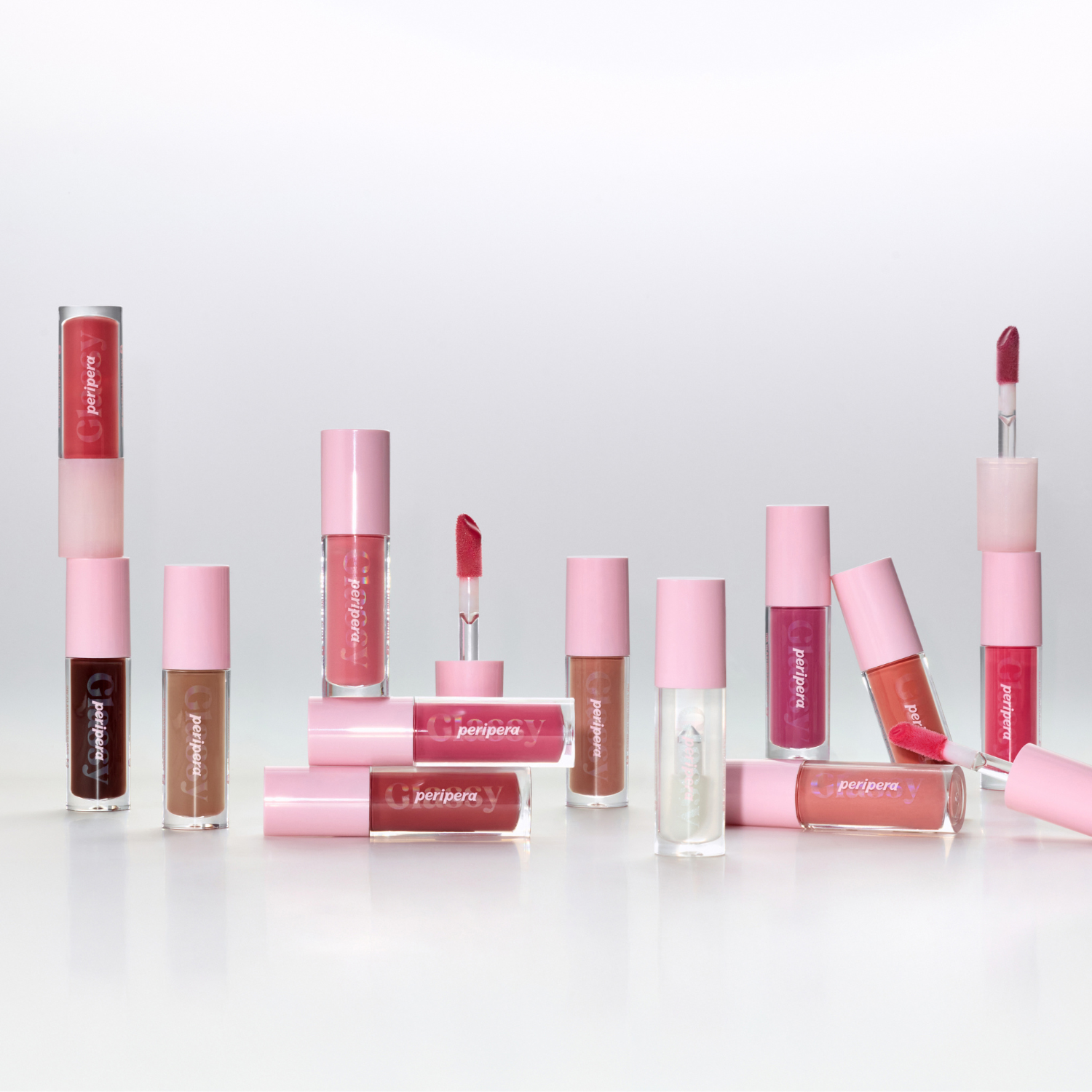 Peripera Ink Glasting Lip Gloss in a clear tube showing glossy, vibrant lip color with a smooth, shiny finish.