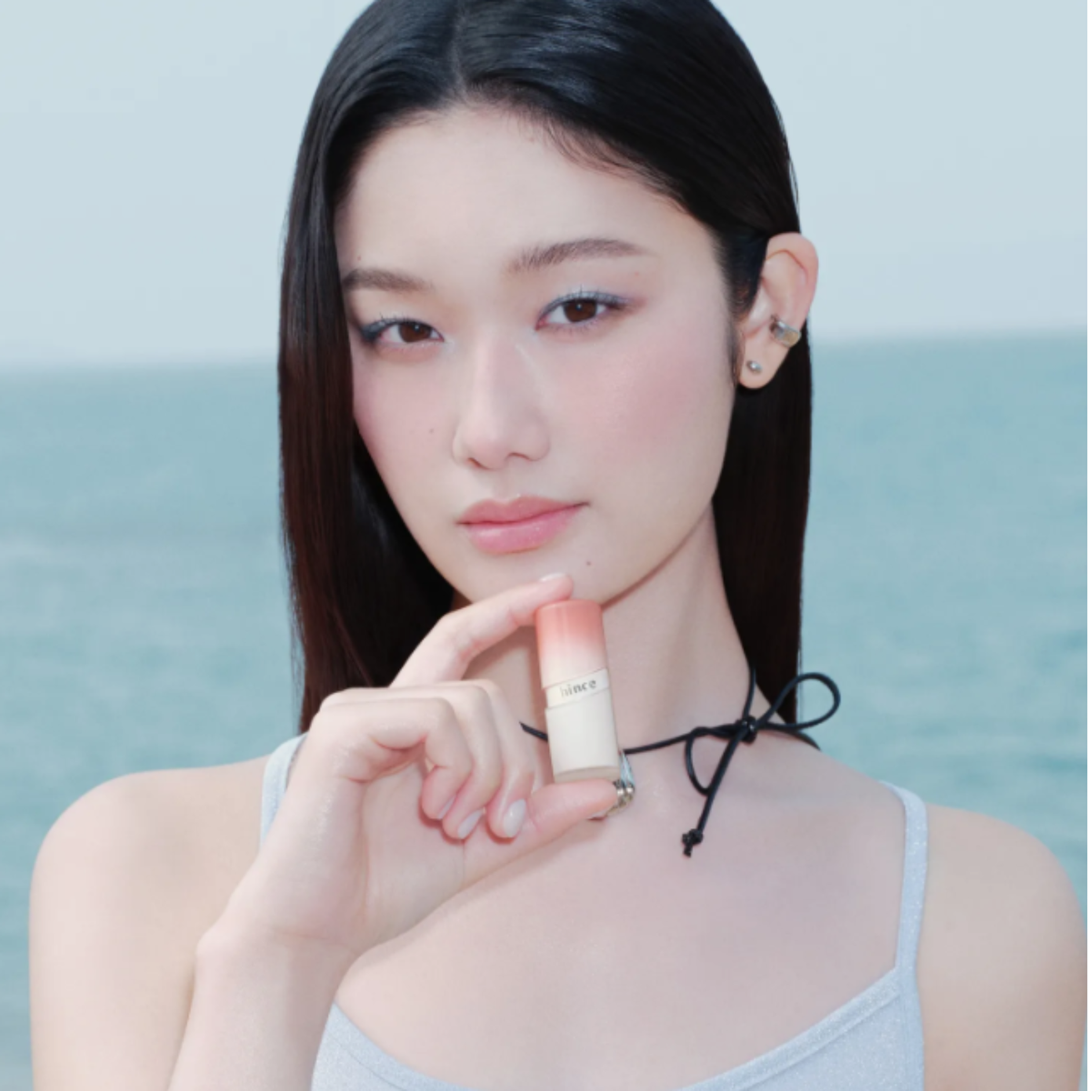 Hince Mirror Dew Gloss lip gloss in clear, shiny finish with a sleek applicator brush, perfect for a glossy, mirror-like shine.