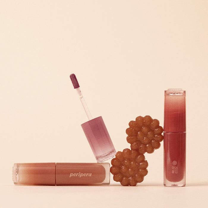 Peripera Ink Mood Glowy Tint Honey K-ookie version lip tint in a warm honey shade, showing the product tube and applicator.