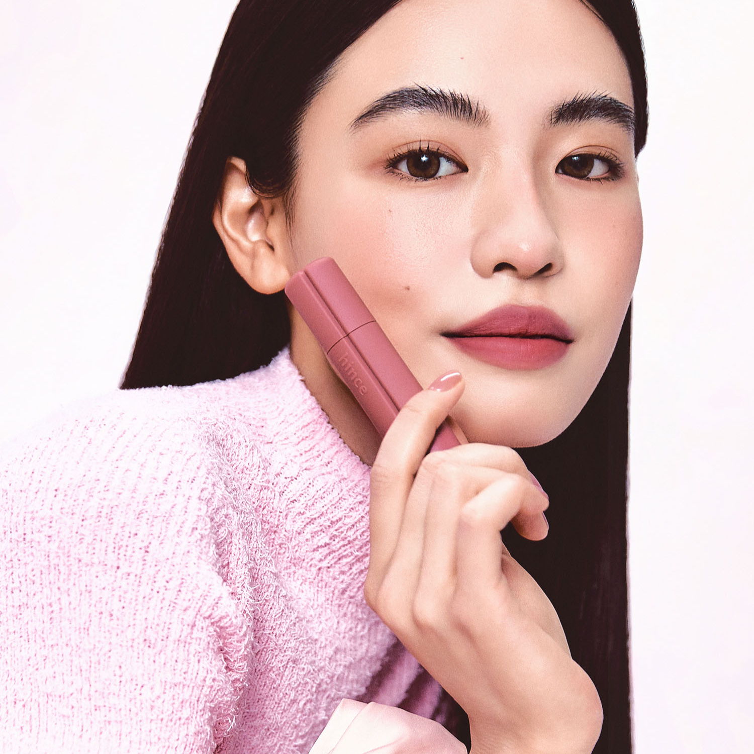Hince Nu Blur Tint lip tint in a soft pink shade, applied on lips showing smooth, natural finish and subtle color.