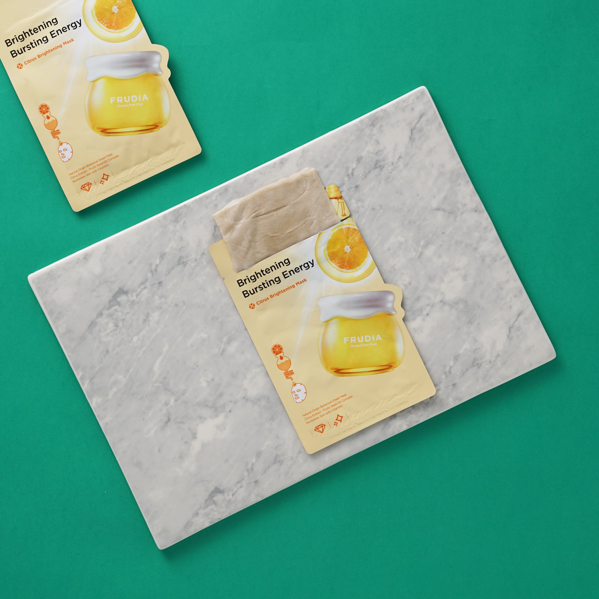 Frudia Citrus Brightening Sheet Mask with vibrant citrus slices and refreshing texture, designed to enhance skin brightness.
