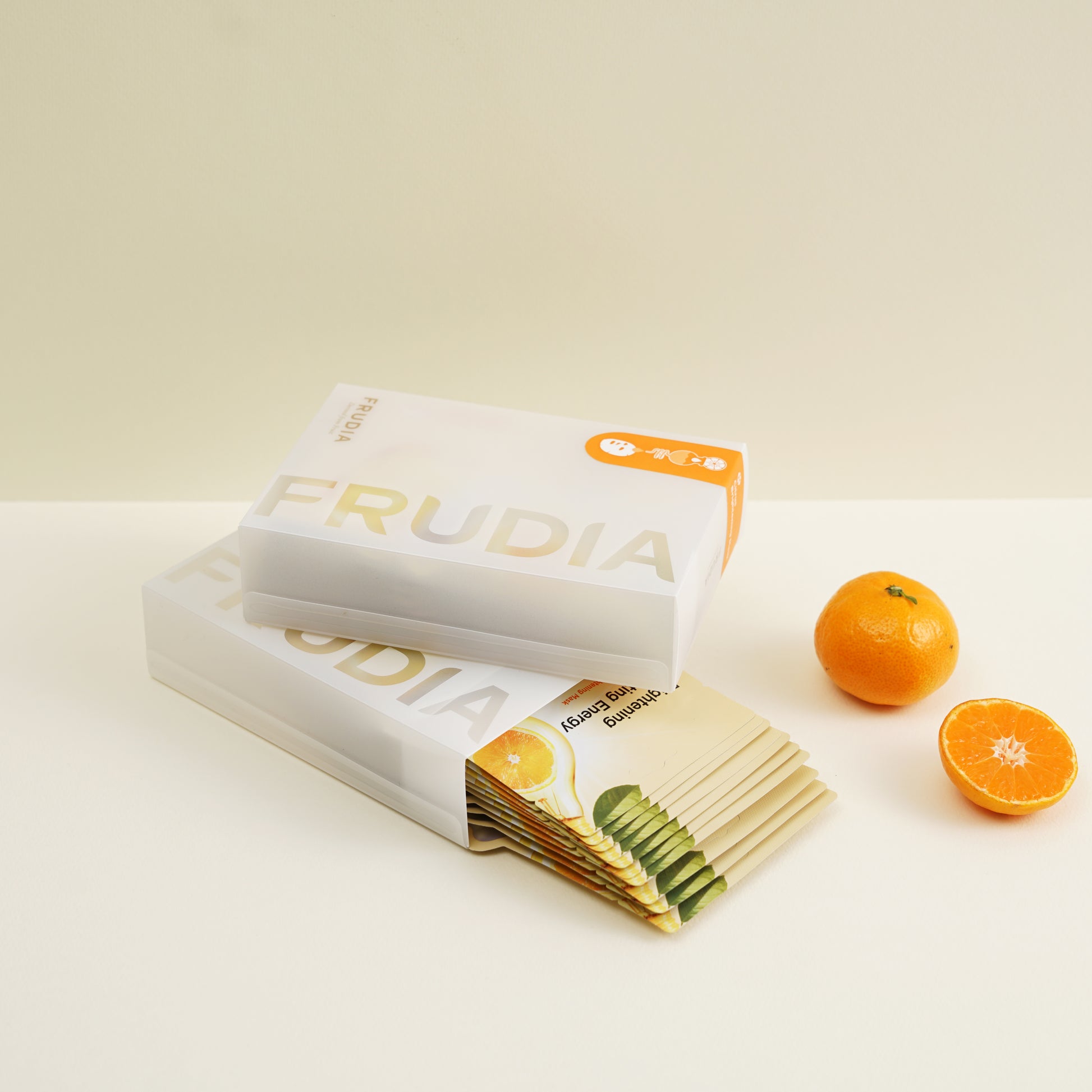 Frudia Citrus Brightening Sheet Mask with citrus extract for glowing skin, shown on a model's face.