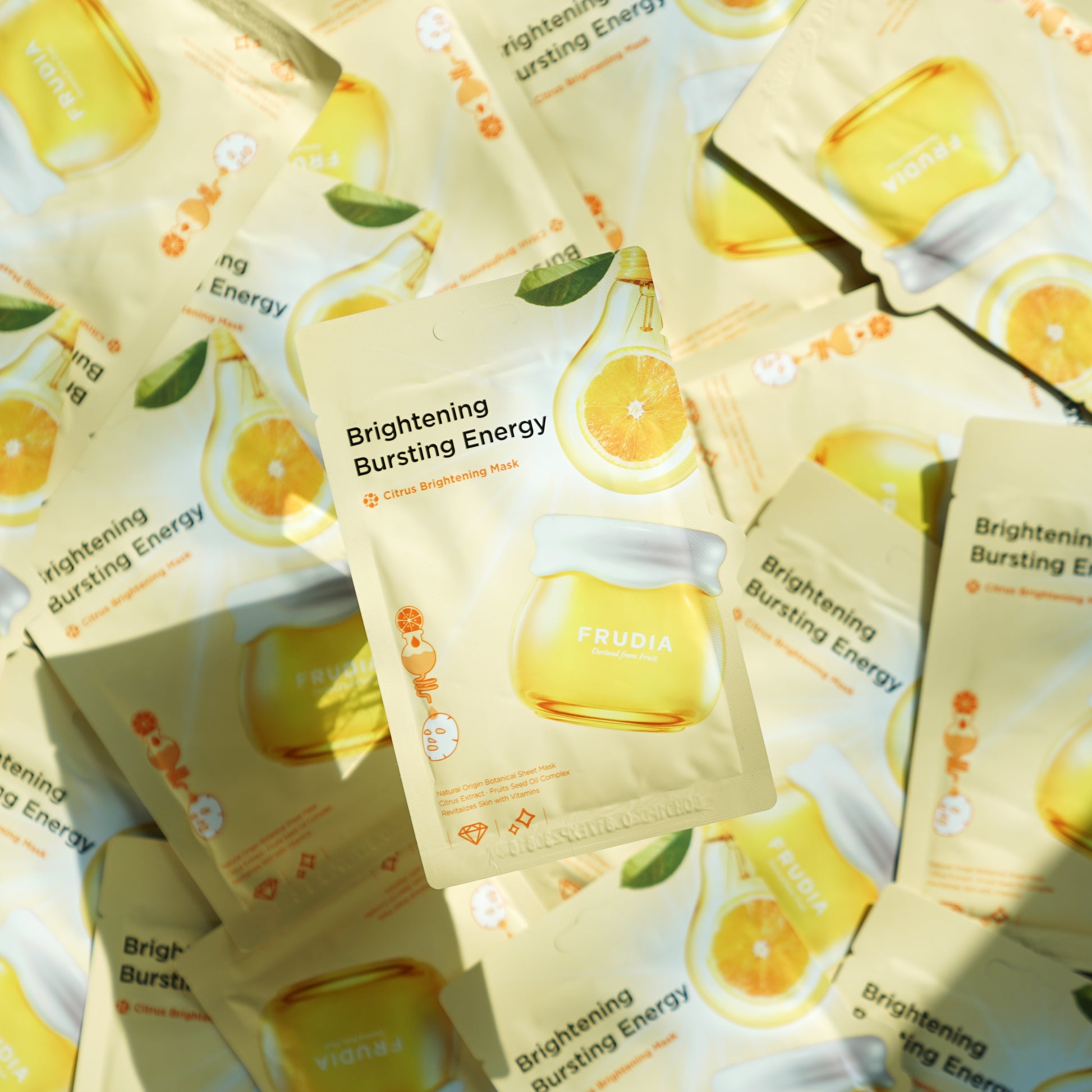 Frudia Citrus Brightening Sheet Mask with citrus extracts, showing the mask sheet spread out on a white background.