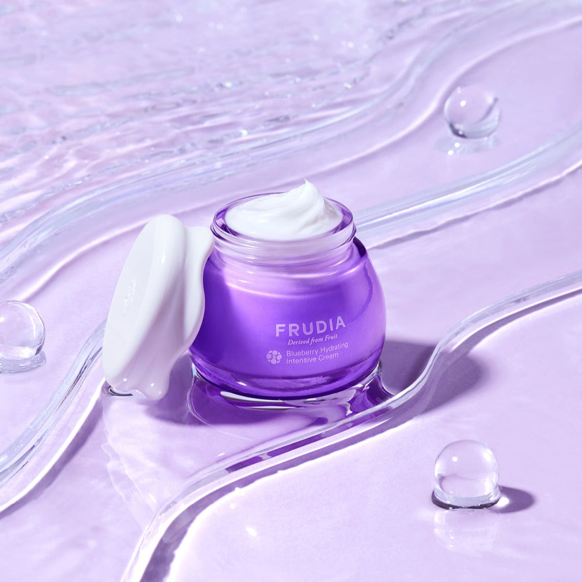 Frudia Blueberry Hydrating Intensive Cream face moisturizer jar with blue and white packaging and a smooth cream texture inside.