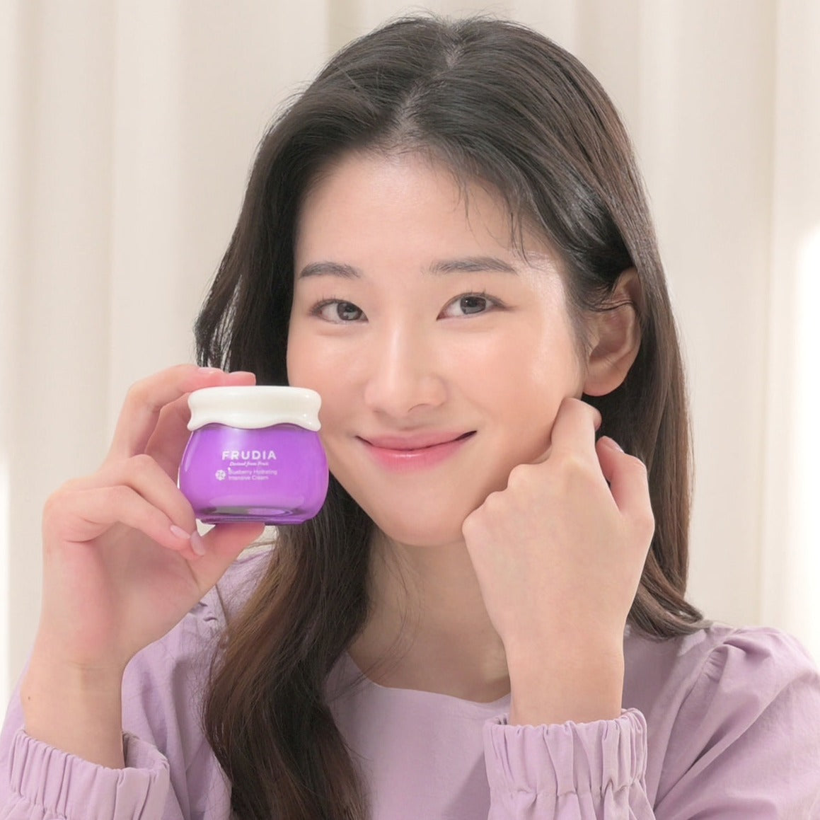 Frudia Blueberry Hydrating Intensive Cream face moisturizer jar with blue and white packaging, showcasing a smooth cream texture.