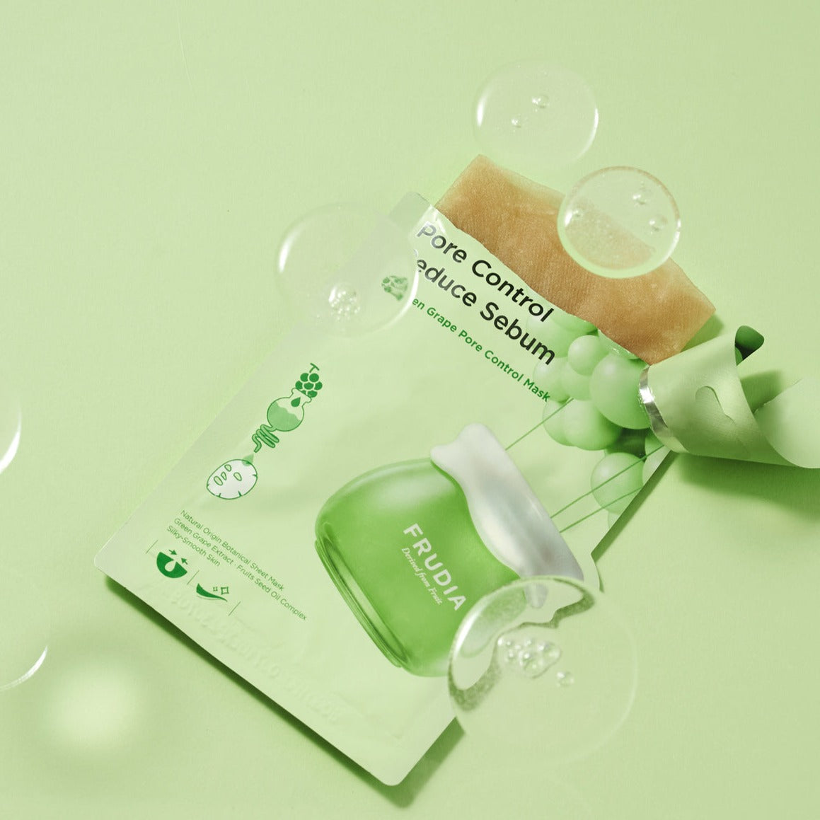 Frudia green grape pore control sheet mask with a sheet soaked in green grape essence, ready for skincare application.