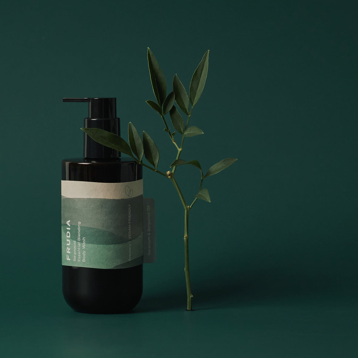 Frudia Re:proust Greenery Body Wash and Scrub in 300ml bottle with natural green plant accents visible.