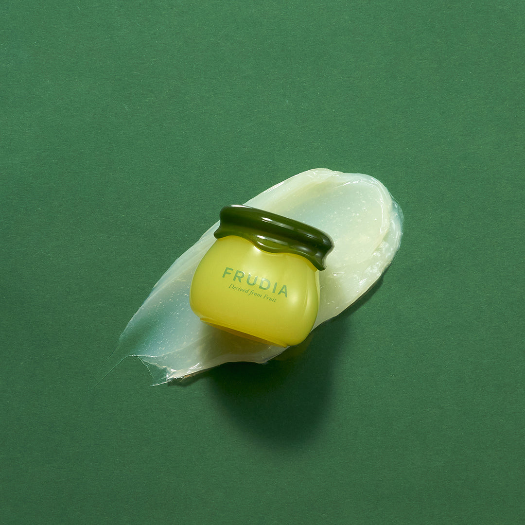 Frudia Avocado Cica Relief Lip Balm 10ml showing a tube with green and white packaging, designed for soothing and nourishing lips.