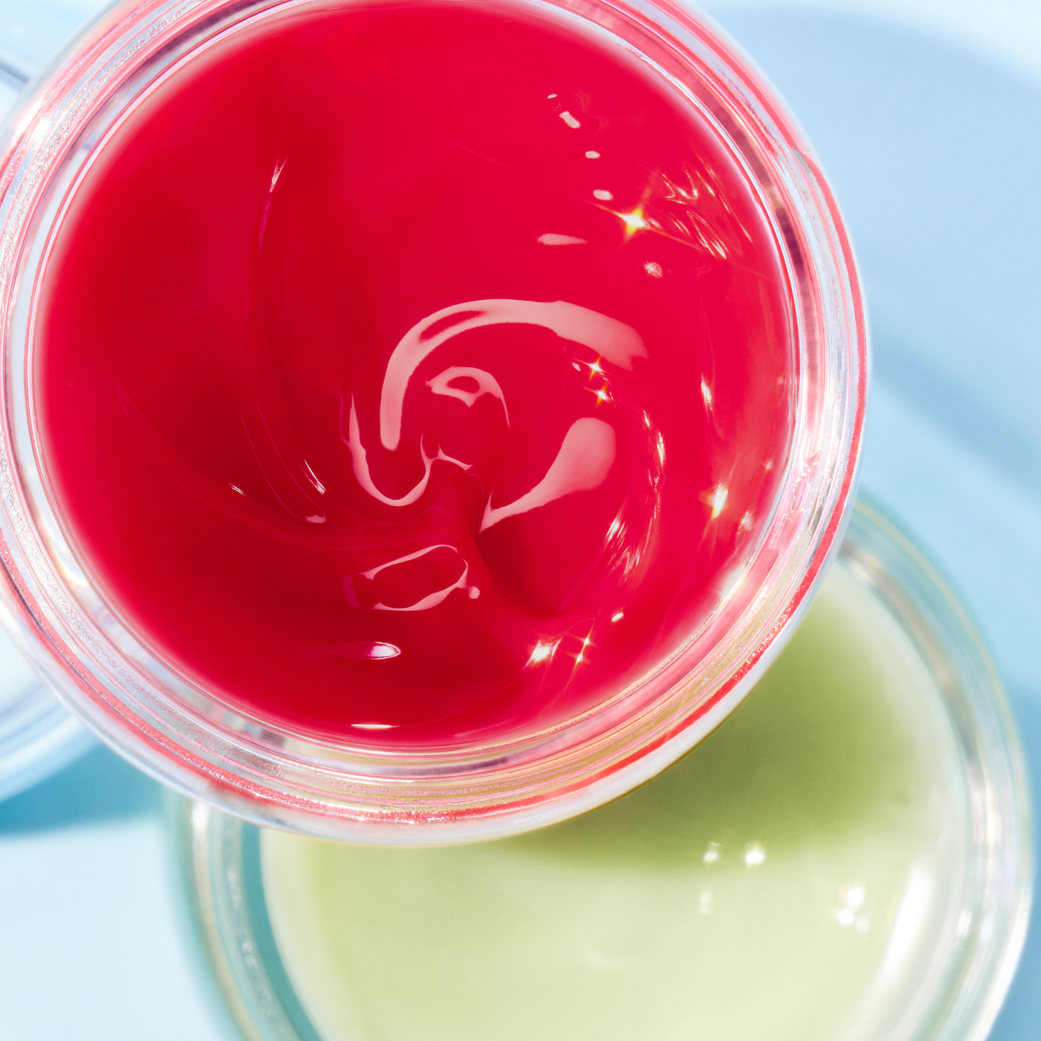 Colorgram Tintin Dory Lip Tint jar showing vibrant coral-colored lip balm in a clear container with a white lid.
