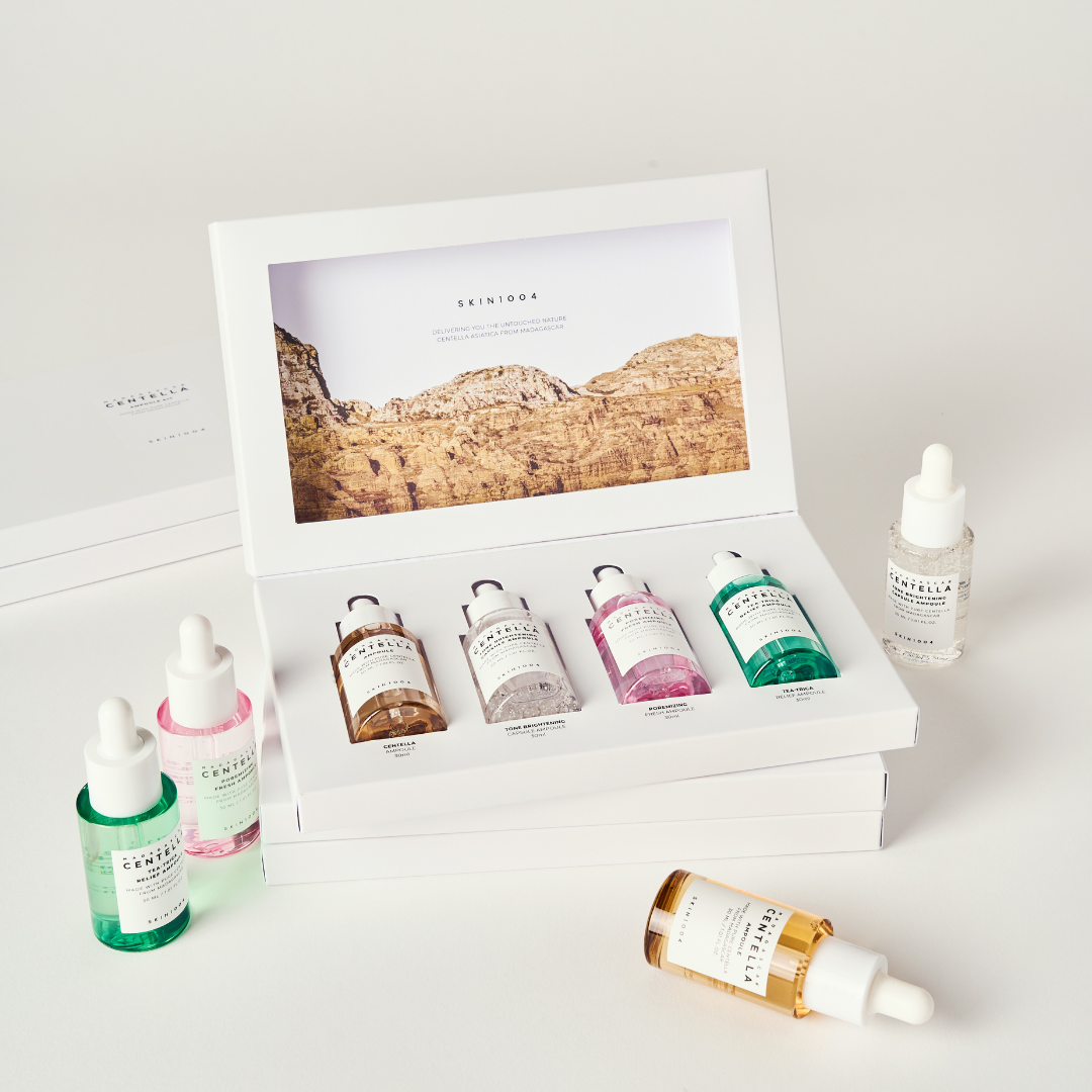SKIN1004 Madagascar Centella Ampoule Kit with serum bottles and skincare products arranged on a white background.