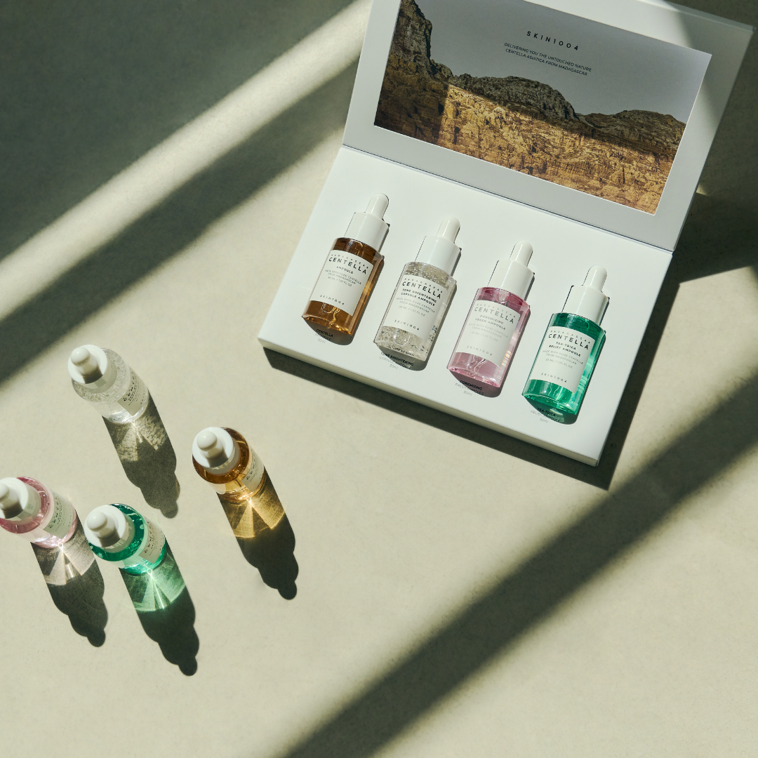 SKIN1004 Madagascar Centella Ampoule Kit with multiple serum bottles and dropper applicators on a white background.
