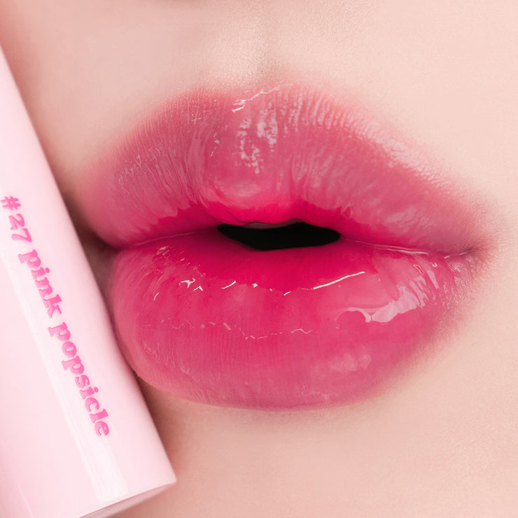 Rom&nd Juicy Lasting Tint lip tint tube with applicator showing vibrant coral color and sleek packaging.