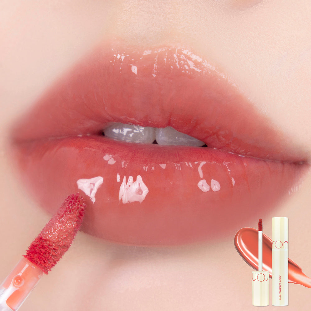 Rom&nd Juicy Lasting Tint lip tint tube with the applicator visible, showcasing vibrant color and sleek packaging.