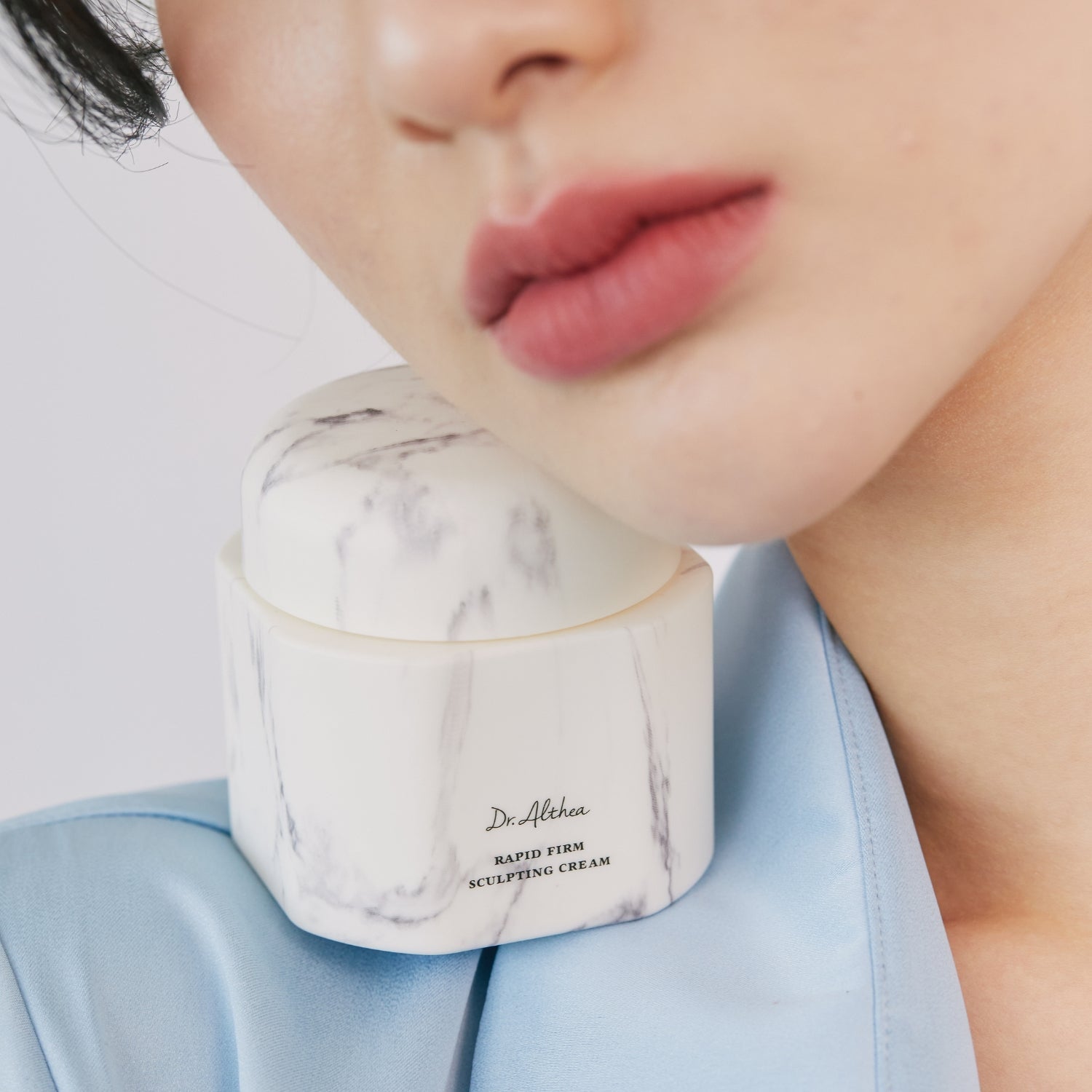 Dr. Althea Rapid Firm Sculpting Cream in 45ml jar, a face moisturizer with a smooth, creamy texture for firming and sculpting skin.