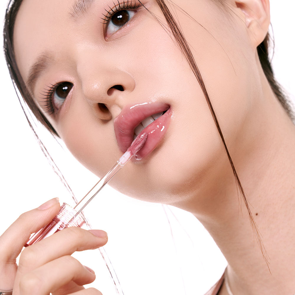 Rom&nd Glasting Color Gloss lip gloss set with 8 vibrant shades in sleek tubes, showcased in a close-up image.
