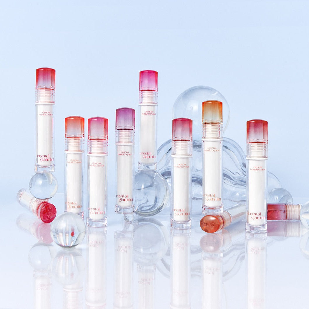 Clio Crystal Glam Lip Tint in a sleek tube, showcasing a vibrant, glossy pink lip tint with a shiny finish and clear packaging.