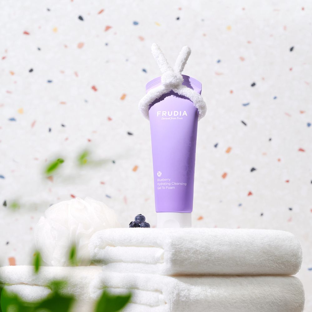 Frudia Blueberry Hydrating Cleansing Gel to Foam in 145ml tube, showing the gel and foam texture for gentle skin cleansing.