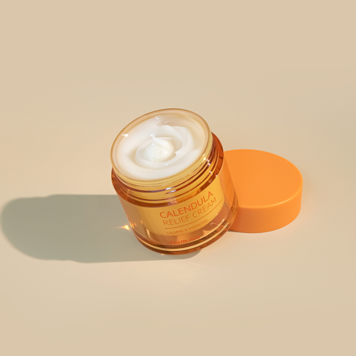 Farmstay Calendula Relief Cream face moisturizer in 80ml jar, creamy texture with calendula flowers for soothing skin.