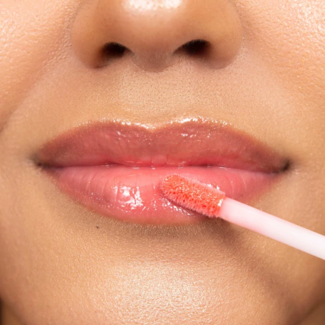 ARTDECO Lip Brilliance Lip Tint in a sleek tube with the tinted gloss visible, showcasing its shiny, vibrant color.