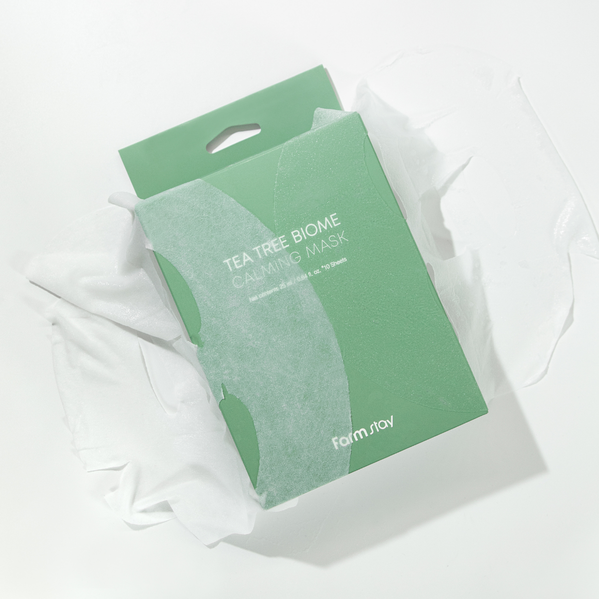 Farmstay Tea Tree Biome Calming Sheet Mask pack with 10 masks, showing individual mask sheets with tea tree ingredients for soothing skin.