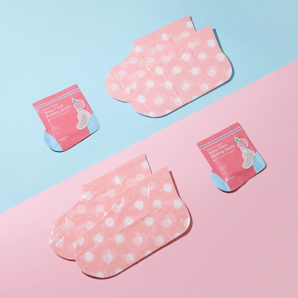 Pair of Frudia My Orchard Peach Foot Peeling Masks showing peach-scented foot mask packets on a clean surface.