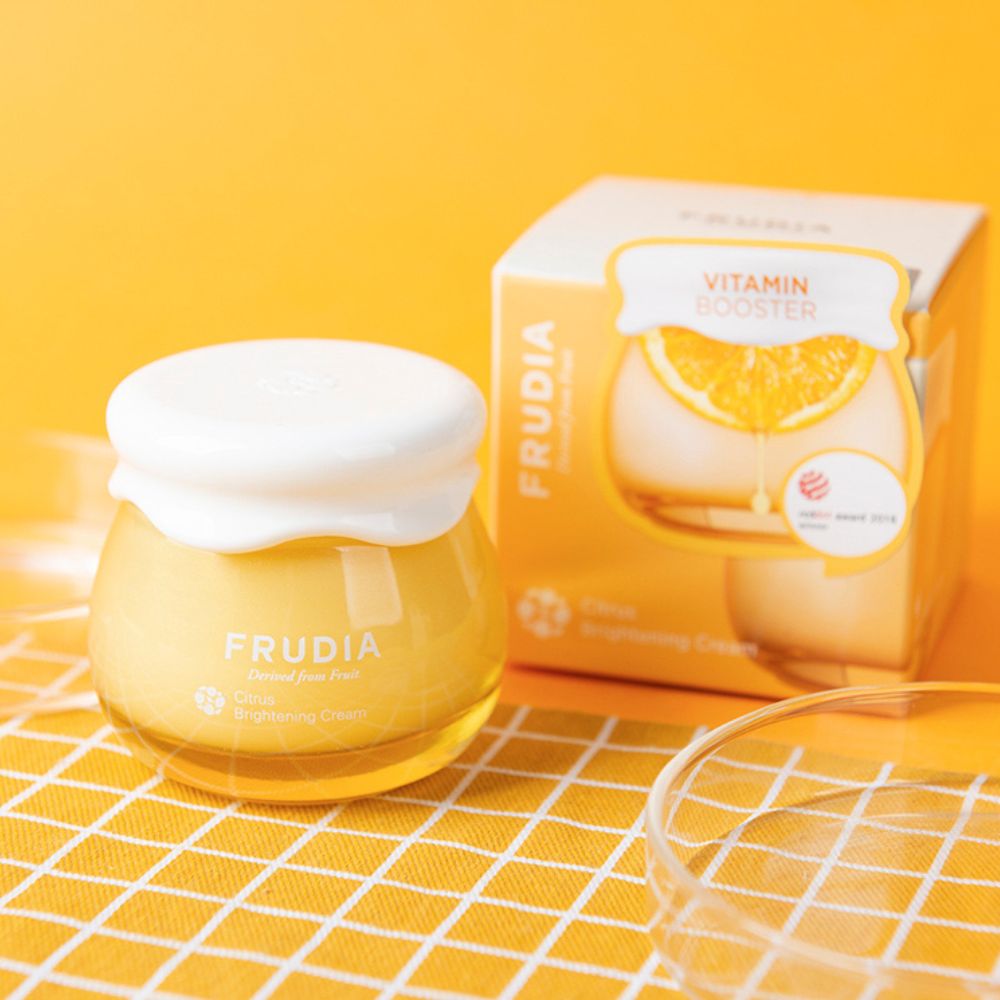 Frudia Citrus Brightening Cream face moisturizer with citrus extracts, smooth textured cream in a white jar.