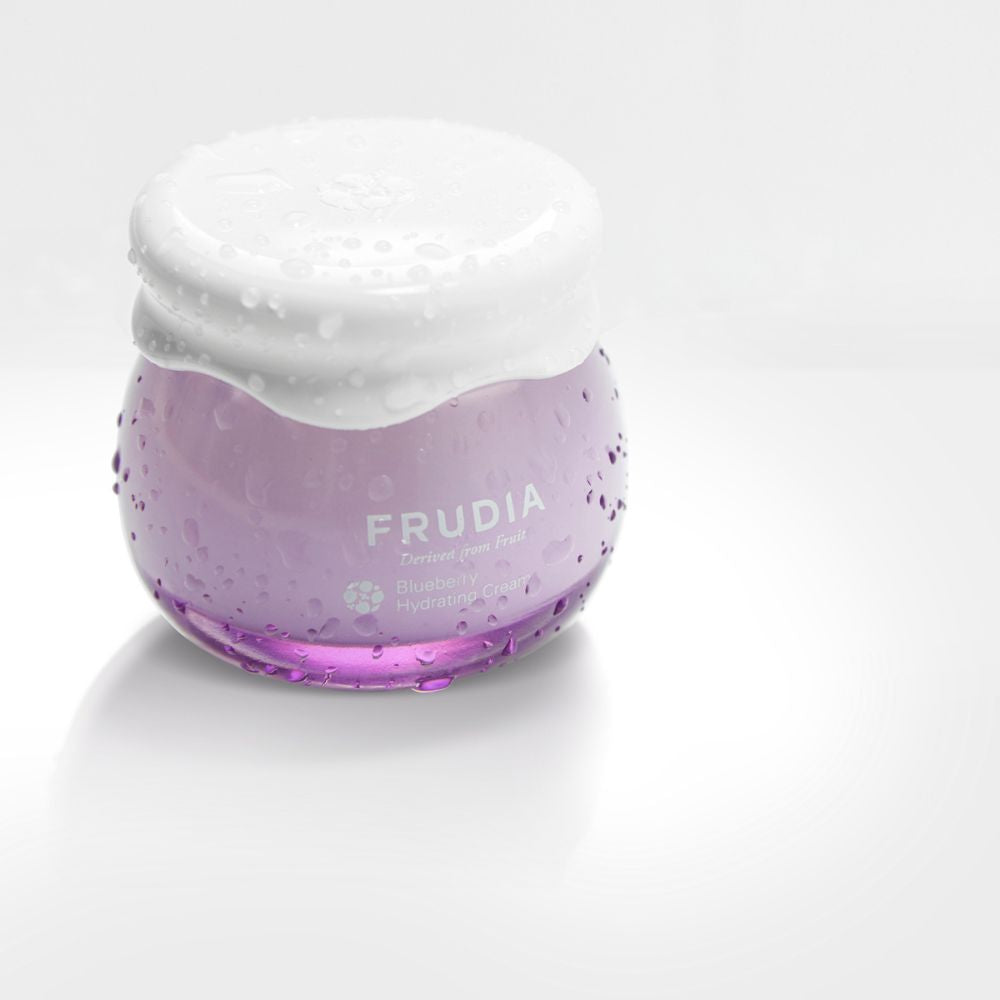Frudia Blueberry Hydrating Face Moisturizer in 55g jar, showing the blue cream texture and packaging.