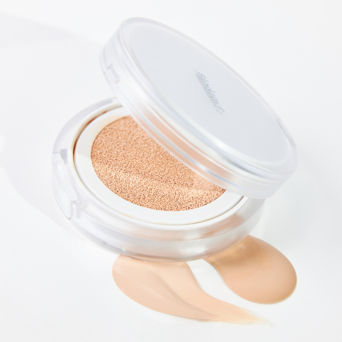 Biodance Radiant Pure Essence Cushion foundation in a compact with a mirror, showing the cushion applicator and product packaging.