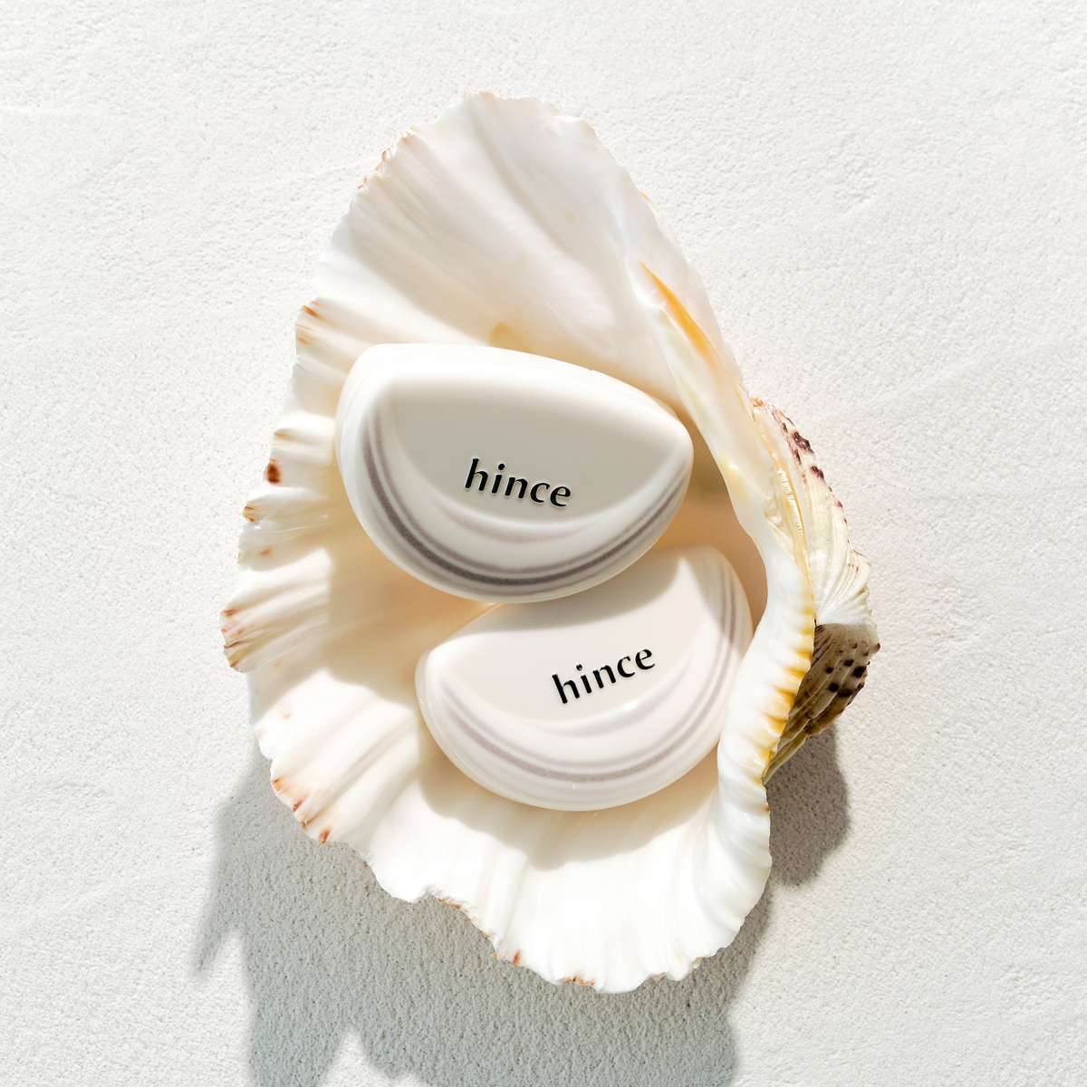Hince Half-Moon Cheek blush in Chill Voyage edition, cream to powder formula, featuring soft pink and peach tones in a compact.