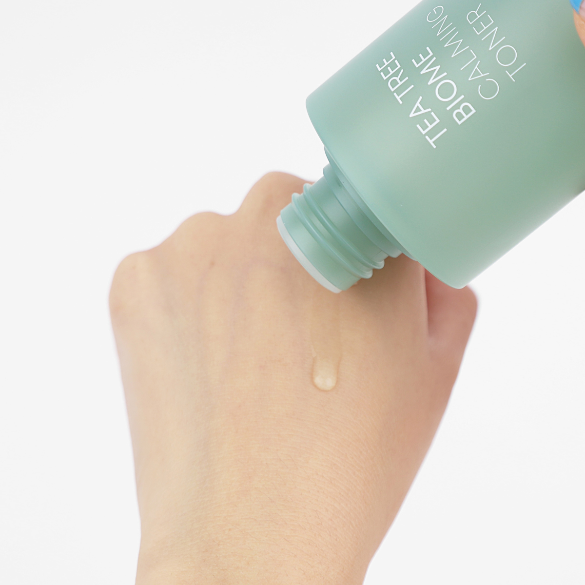 Farmstay Tea Tree Biome Calming Toner in 200ml bottle, featuring clear liquid and green label with natural ingredients.