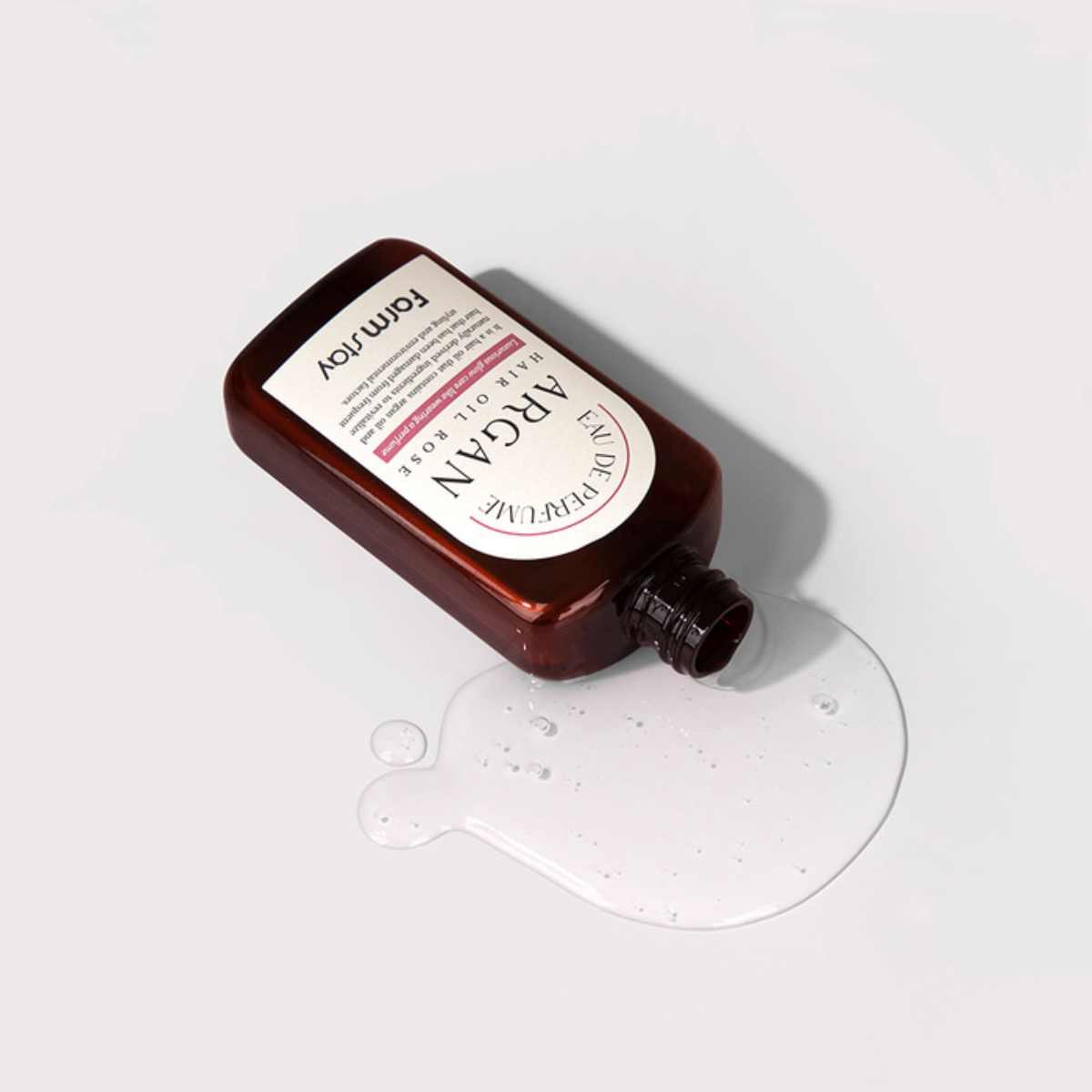 Farmstay Argan Hair Oil Rose Eau de Perfume conditioner and treatment bottle, 100ml, with floral rose scent and nourishing formula.