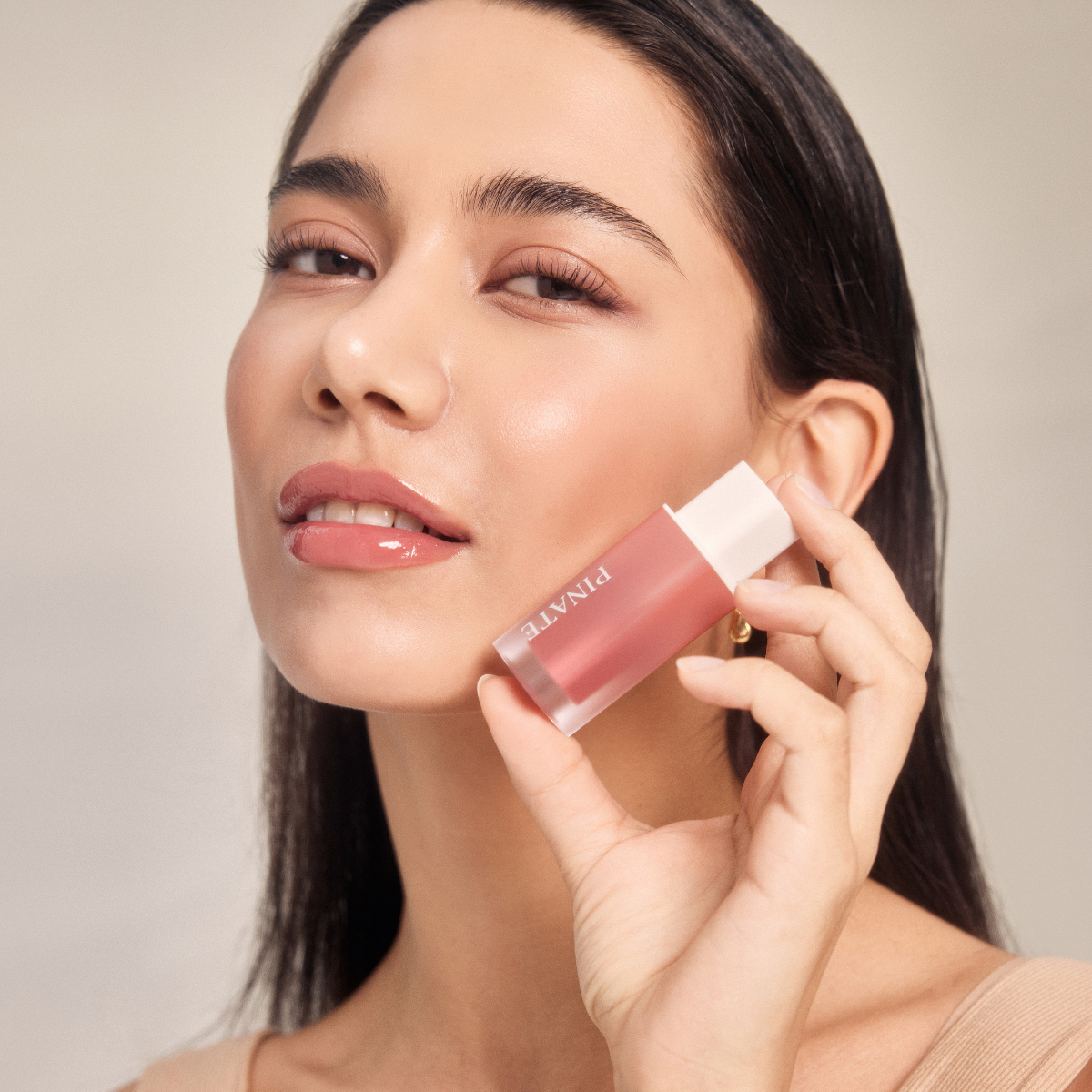 Pinate Natural Bloom Lip Oil Serum in clear lip gloss tube, moisturizing lip gloss with natural ingredients and shiny finish