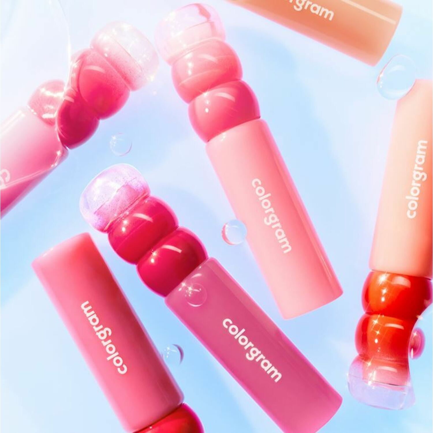 Colorgram Fruity Water Lip Tint in a clear bottle, showing a vibrant, fruity-colored liquid for natural, glossy lip color.