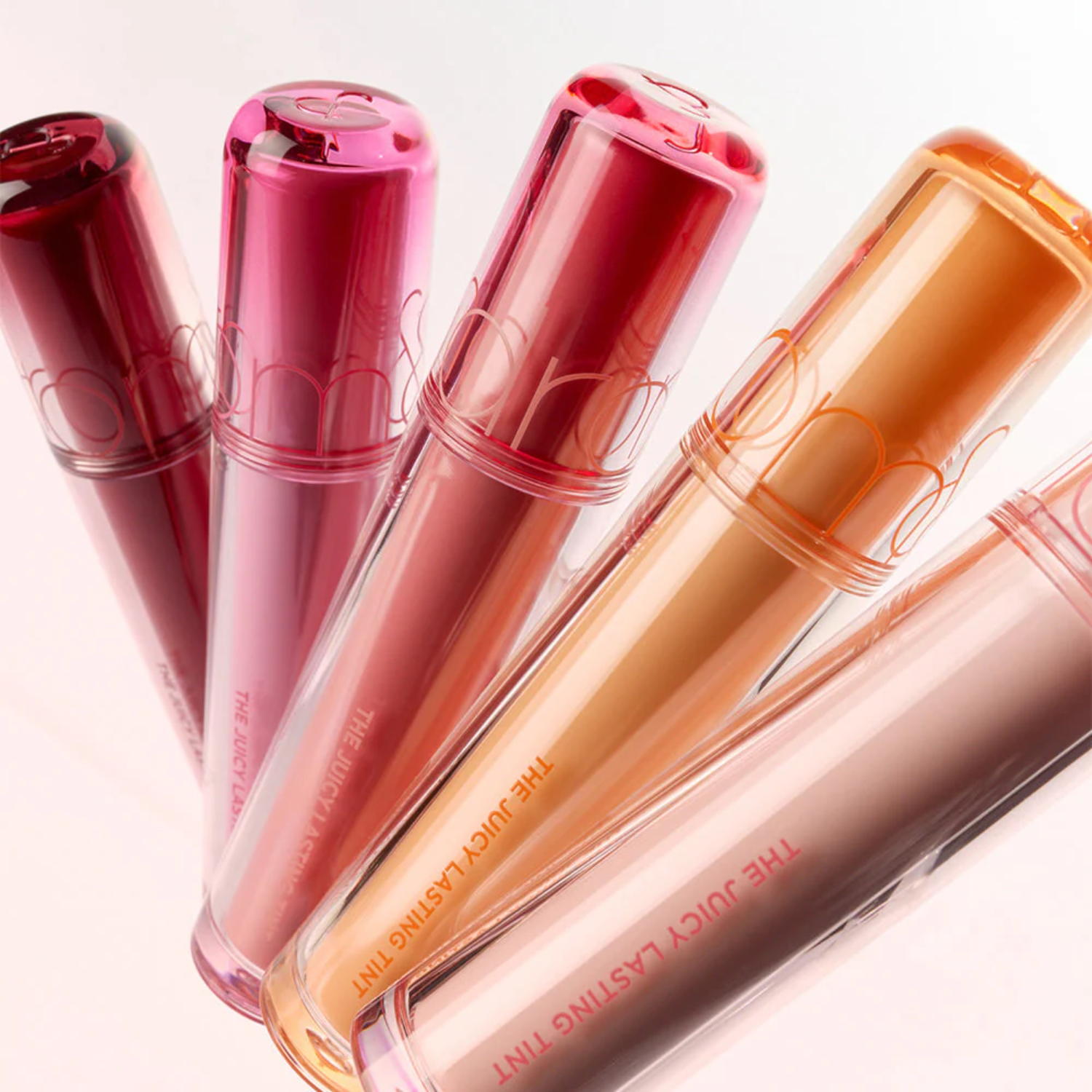 Rom&nd Juicy Lasting Lip Tint in vibrant shade, showing the smooth, glossy application on lips with a close-up view.