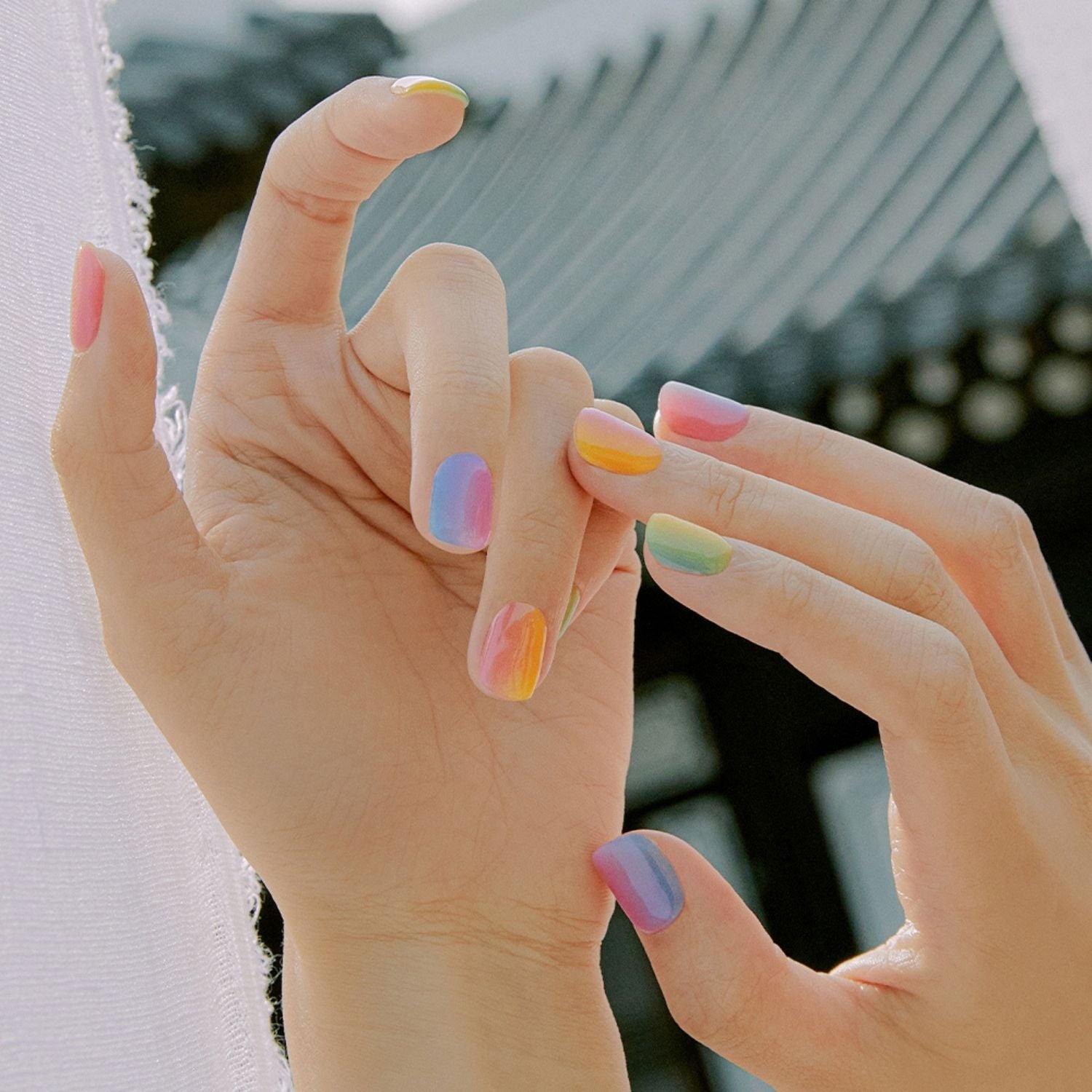 Semi-cured gel nails in pastel shades by Ohora, showcasing a smooth, glossy finish on neatly shaped nails.